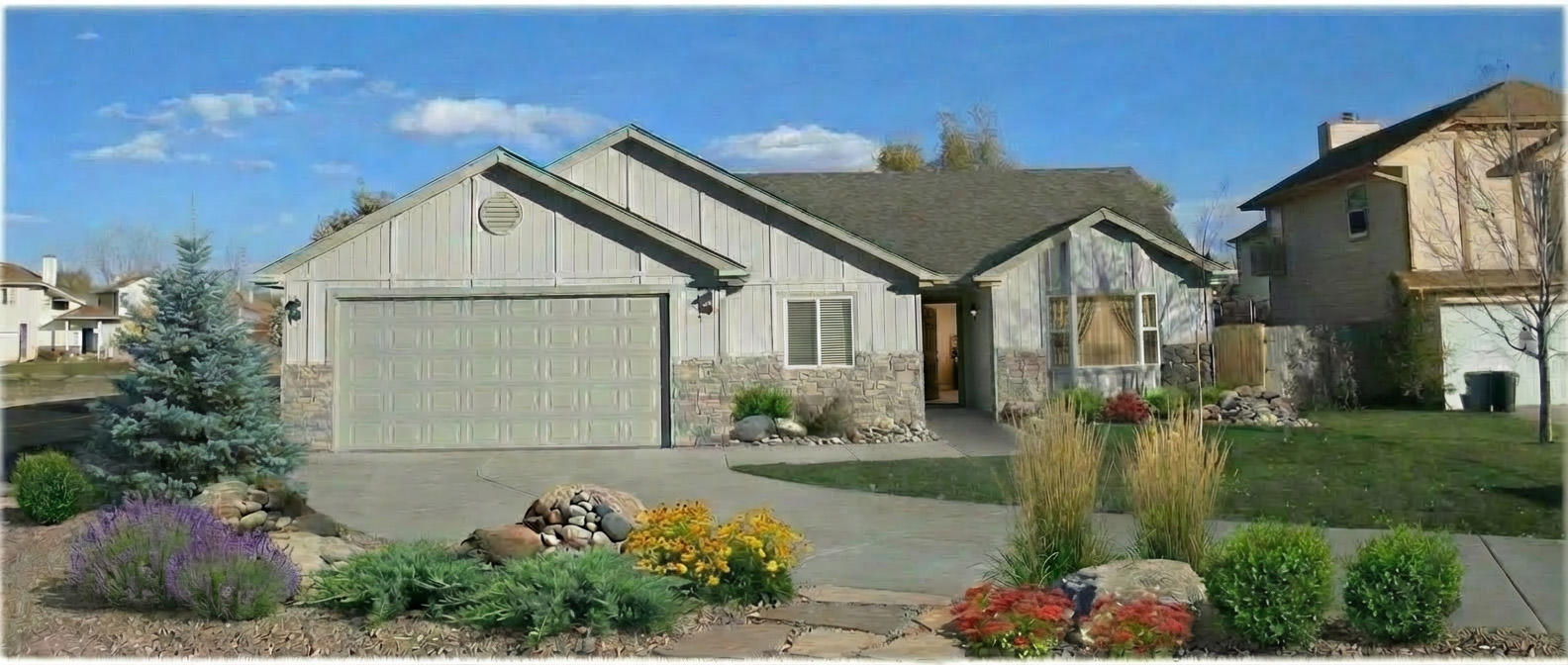 Single-story visitable home with zero-step entrance, wide driveway, and beautiful landscaping.